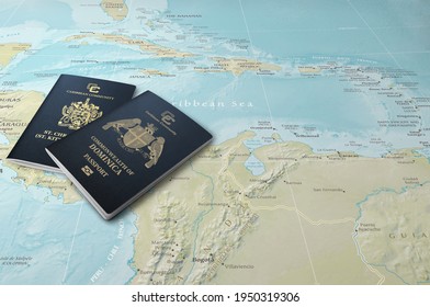 Passports of two Caribbean states, Saint Kitts and Nevis and Dominica on a map of the Caribbean Sea - Shutterstock ID 1950319306