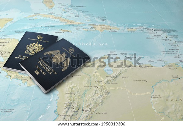 Passports of two Caribbean\
states, Saint Kitts and Nevis and Dominica on a map of the\
Caribbean Sea
