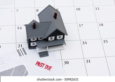 A Past Due Bill Sitting With A Model House On A Calendar, Behind On Your Mortgage Payments