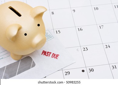 A Past Due Bill Sitting With A Piggy Bank On A Calendar, Behind On Your Bills