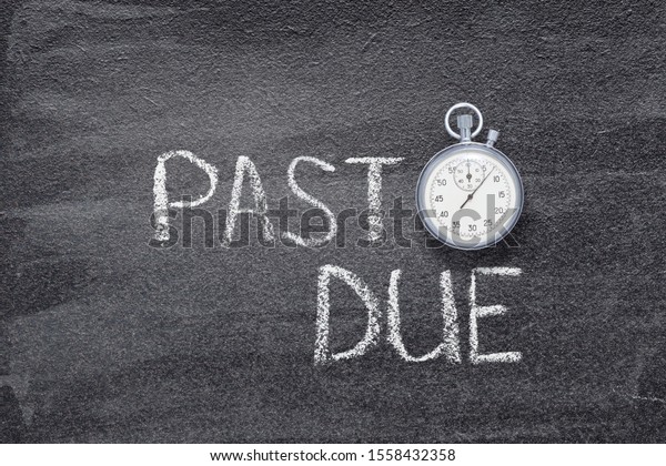past due phrase written on chalkboard with vintage\
precise stopwatch \
\
