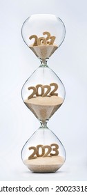 Past, Present And Future Concept. 3 Part Hourglass. Falling Sand Taking The Shape Of Years 2021, 2022 And 2023.