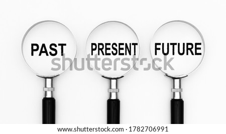 Past present and future text under magnifying lenses