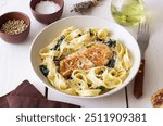 Pasta alfredo with chicken, spinach and cheese. Italian food