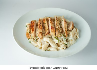  Pasta Alfredo With White Sauce And Grilled Chicken Breast On White Background