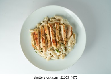  Pasta Alfredo With White Sauce And Grilled Chicken Breast On White Background