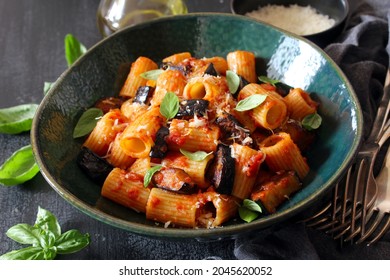 Pasta alla norma - Italian pasta with eggplante, tomato sauce and parmesan cheese on dark background. Top view. Healthy food. - Powered by Shutterstock