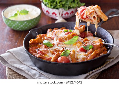 Pasta bake with whole wheat penne, tomatoes and mozarella