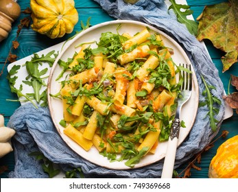 Pasta With Baked Pumpkin, Arugula And Onion. Rustic Green Autumn Background With Pumpkins And Dry Leaves. Fall Food Still Life Flat Lay