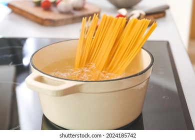 Pasta boiling in cooking pot on electric stove - Powered by Shutterstock