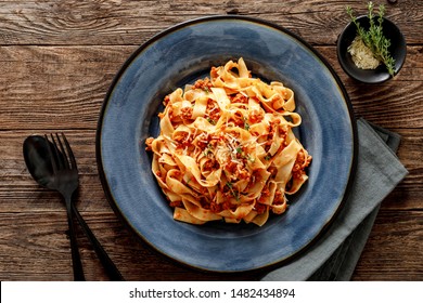 Pasta Bolognese. Traditional Italian Dish Of Pasta With Tomato And Meat Mince Sauce Served In A Plate With Parmesan Cheese And Thyme, Top View