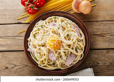 Pasta Carbonara On A Plate With Egg Yolk And Parmesan Cheese