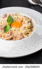 Pasta Carbonara. Spaghetti With Bacon, Parmesan, Cream Sauce And Egg Yolk. Macro Close-up Isolated On A White Round Plate. Mediterranean Gourmet Food.