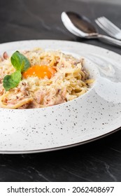 Pasta Carbonara. Spaghetti With Bacon, Parmesan, Cream Sauce And Egg Yolk. Macro Close-up Isolated On A White Round Plate. Mediterranean Gourmet Food.