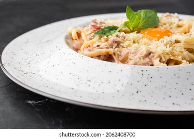 Pasta Carbonara. Spaghetti With Bacon, Parmesan, Cream Sauce And Egg Yolk. Macro Close-up Isolated On A White Round Plate. Mediterranean Gourmet Food.