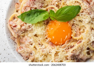 Pasta Carbonara. Spaghetti With Bacon, Parmesan, Cream Sauce And Egg Yolk. Macro Close-up Isolated On A White Round Plate. Mediterranean Gourmet Food.