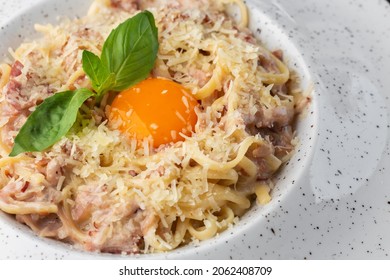 Pasta Carbonara. Spaghetti With Bacon, Parmesan, Cream Sauce And Egg Yolk. Macro Close-up Isolated On A White Round Plate. Mediterranean Gourmet Food.