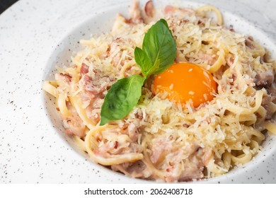 Pasta Carbonara. Spaghetti With Bacon, Parmesan, Cream Sauce And Egg Yolk. Macro Close-up Isolated On A White Round Plate. Mediterranean Gourmet Food.