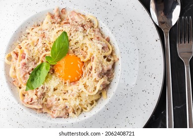 Pasta Carbonara. Spaghetti With Bacon, Parmesan, Cream Sauce And Egg Yolk. Macro Close-up Isolated On A White Round Plate. Mediterranean Gourmet Food.