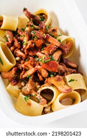 Pasta With Chanterelle Mushrooms In A Plastic Takeout Container