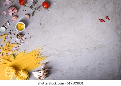 Pasta With Cooking Ingredients On Grey Countertop. Italian Recipe. View From Above, Copy Space, Flat Lay.