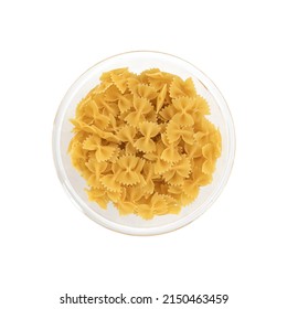 pasta farfalle in glass bowl isolated on white background, raw pasta in shape of bow, top view