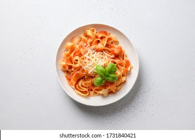 Pasta Fettuccine With Tomato Sauce With Basil On White Background. View From Above.