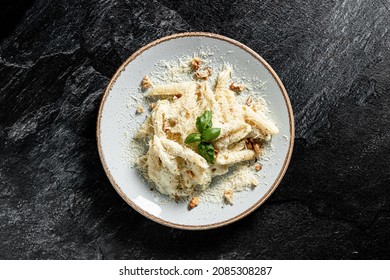 Pasta four cheeses. Italian food. On a wooden background. Top view. Free space for text.