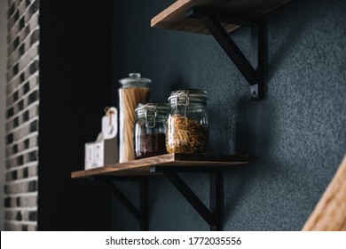 Pasta and grocery in glass jars on a wooden shelf in the kitchen. Detail - Powered by Shutterstock