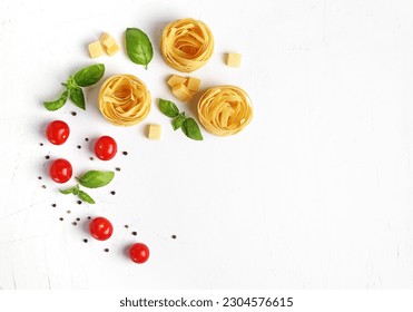 Pasta ingredients on white background. Red cherry tomatoes, basil, peppercorns. Italian cuisine concept. Healthy vegetarian diet. Flat lay, copy space - Powered by Shutterstock