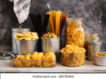 Pasta. Italian Pasta. Italian Food Cooking Ingredients With Tagliatelle, Penne, Tortellini, Ravioli, Mafalda Pasta In Storage Jars.