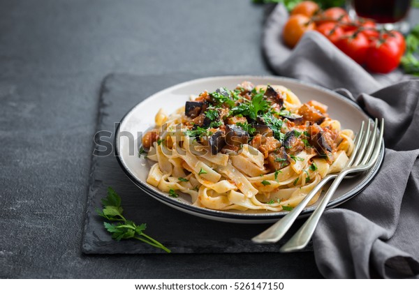 pasta linguine with eggplant and parmesan\
cheese, dark background, selective\
focus