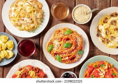 Pasta, Many Different Varieties, Overhead Flat Lay Shot. Italian Food And Drinks, Shot From The Top. Spaghetti In Tomato Sauce, Mushroom Pasta, Bolognese, With Wine, On A Rustic Wooden Background