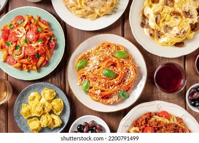 Pasta, Many Different Varieties, Overhead Flat Lay Shot. Italian Food And Drinks, Shot From The Top. Spaghetti In Tomato Sauce, Mushroom Pasta, Chicken Penne Etc, With Red Wine