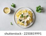 Pasta mushrooms with chicken, parmesa and basil on white backgroun, copy space, top view