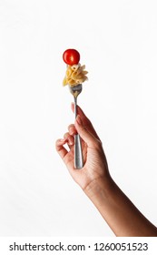 
pasta on a fork in hand on white background