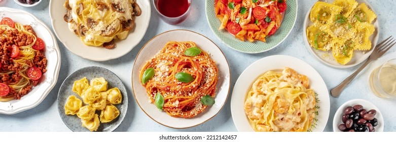 Pasta Panorama. Assortment Of Italian Pastas, With Spaghetti In Tomato Sauce And Bolognese, Seafood Pasta, Penne With Chicken, Ravioli And Others, Overhead Flat Lay Shot With Wine And Olives