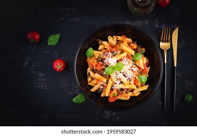 Pasta Penne With Eggplant. Pasta Alla Norma - Traditional Italian Food With Eggplant, Tomato, Ricotta Cheese And Basil. Top View, Overhead, Copy Space