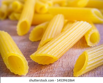 Pasta penne gluten free uncooked on wooden surface - Powered by Shutterstock