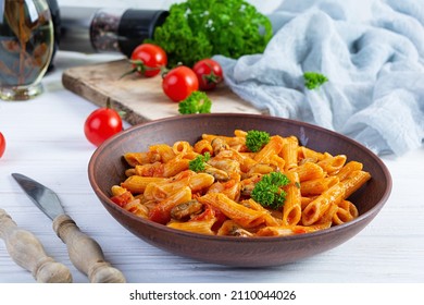 Pasta Penne In Marinara Sauce With Mussels, Onion And Parsley. Classic Italian Pasta Penne