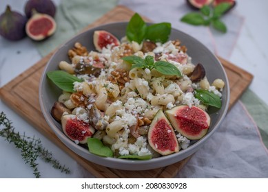 Pasta Salad With Figs And Goat Cheese On A Table