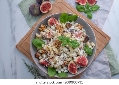 Pasta Salad With Figs And Goat Cheese On A Table