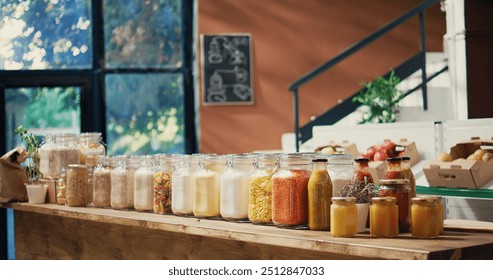 Pasta and sauces in reusable glass jars on store shelves, low carbon footprint sustainable lifestyle organic shop. Empty farmers market filled with bulk products and fresh produce. Handheld shot. - Powered by Shutterstock