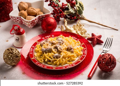 Pasta With Sausage Cream Sauce And Nuts Over Christmas Table