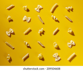 Pasta Shapes On A Yellow Background