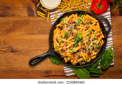 Pasta Skillet Dish Top View. This Quick And Delicious Pasta Meal Is Made With Penne Pasta, Fresh Tomato Sauce And Sausage. Served In A Cast Iron Skillet.