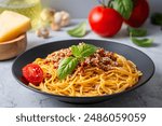 Pasta spaghetti bolognese with minced beef sauce, tomatoes, parmesan cheese and fresh basil in a plate