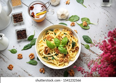 Pasta Spaghetti In A Cream Sauce With Fresh Spinach, Garlic Walnuts