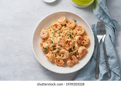 Pasta Spaghetti With Grilled Shrimps Bechamel Sauce. Spaghetti With Seafood Rich Cream. Cooking Mediterranean Food With Savory Prawns, Macro Top View, Blue Table, Italian Cuisine