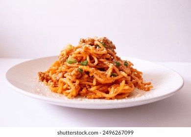 Pasta spaghetti with meat ball parmesan cheese and tomato sauce on a plate white background. Side view.